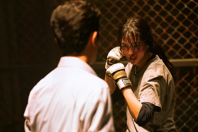 Han So-hee raises her gloved fists during a training scene in My Name.