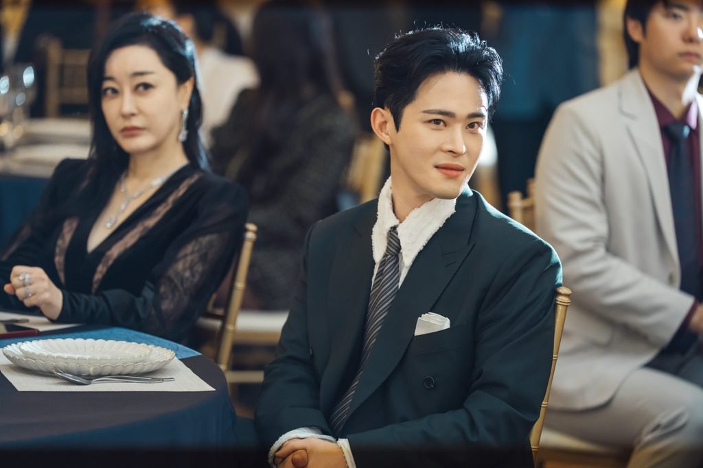 Choi Do-yoon, played by Jeong Jae-kwang, seated at a formal family gathering.
